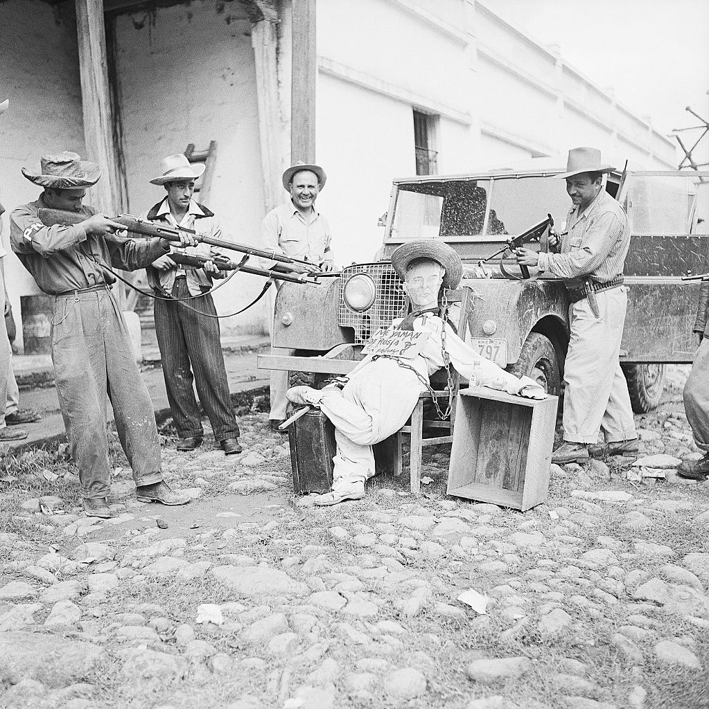 Soldiers Hold Guns on Effigy of Arbenz